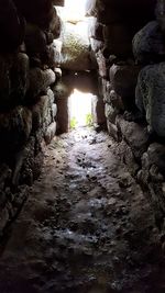 View of stone wall by rocks