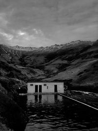 Scenic view of lake by buildings against sky