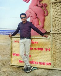 Portrait of young man wearing sunglasses standing outdoors
