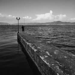 Scenic view of sea against cloudy sky