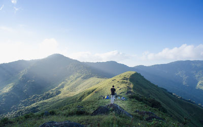 Man standing on mountain against sky