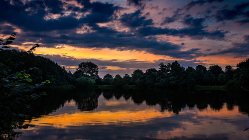 Scenic view of lake against sky at sunset