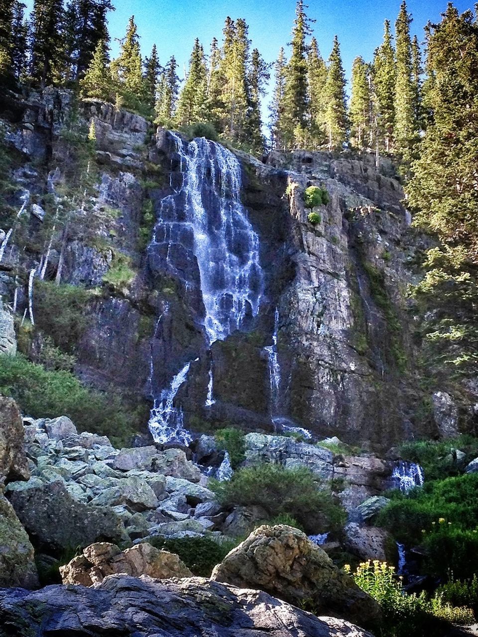 waterfall, flowing water, rock - object, motion, beauty in nature, water, scenics, tree, nature, long exposure, rock formation, low angle view, flowing, forest, tranquility, tranquil scene, day, idyllic, splashing, rock