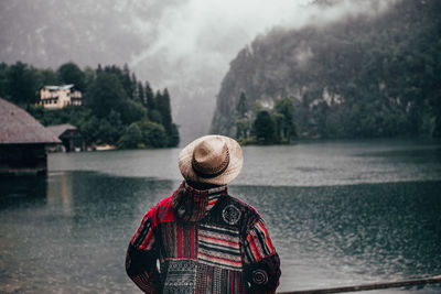 Rear view of man standing by river