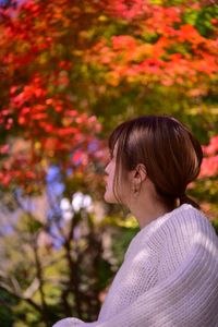 Portrait of woman against plants during autumn