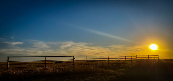 Silhouette landscape against sky during sunset