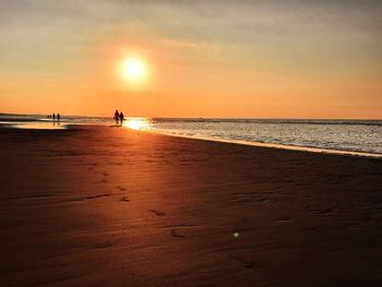 Scenic view of beach against sky during sunset