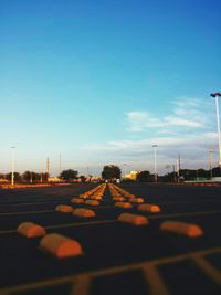 Empty road against blue sky