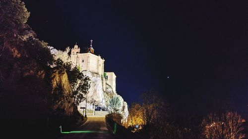 Illuminated building against sky at night