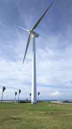 Windmill on field against sky