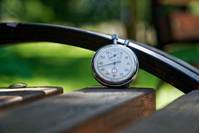 High angle view of stopwatch on bench