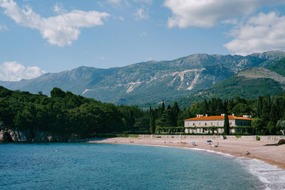 Scenic view of sea and mountains against sky