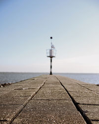 Pier over sea against clear sky