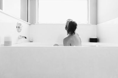 Woman relaxing in bathtub