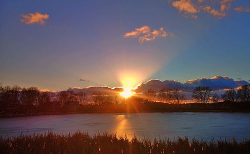 Scenic view of lake against sky during sunset