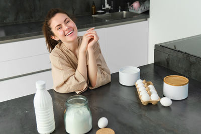 Portrait of young woman drinking coffee