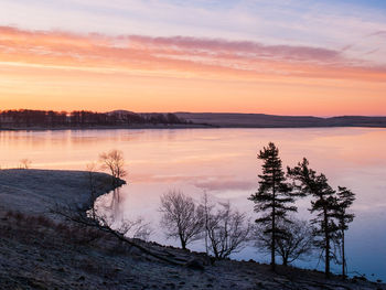 Scenic view of lake against sky during sunset