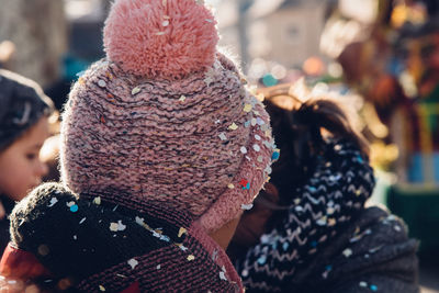 Close-up of girl knit hat covered with confetti