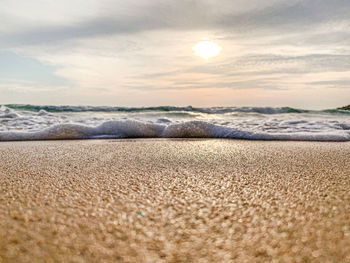 Scenic view of beach against sky during sunset