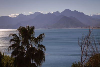 Scenic view of sea and mountains against sky