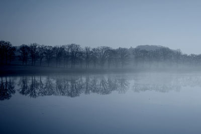 Scenic view of calm lake against clear sky