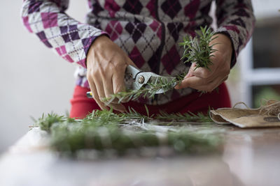 Midsection of person preparing food on table