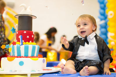 High angle view of cute boy sitting on table