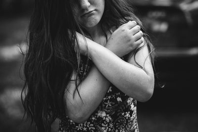 Midsection of woman with arms crossed