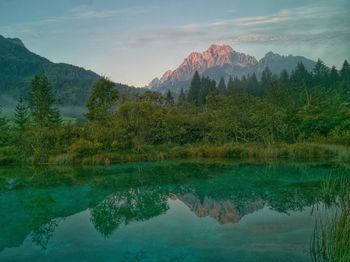 Scenic view of lake and mountains against sky