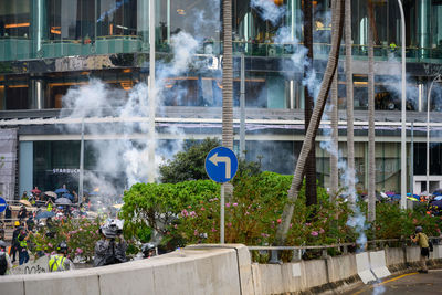 People on street against buildings in city