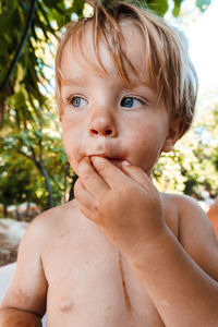 Little boy eating a berry