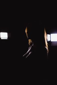 Portrait of woman in dark room