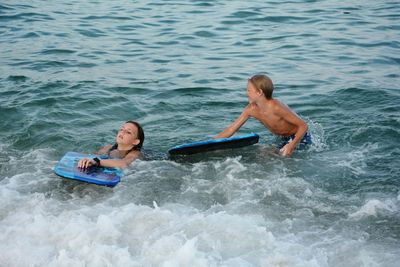 Two children play in the sea