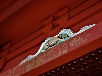 Low angle view of red telephone on metal