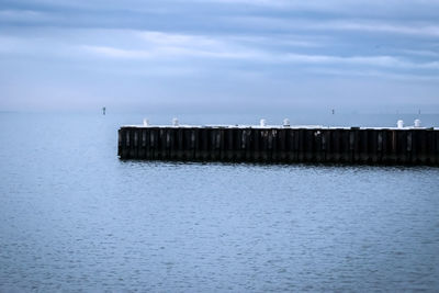 Pier over sea against sky