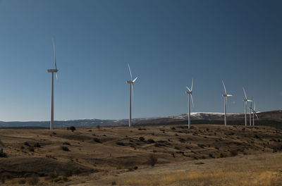 Modern windmills on field against blue sky. shot in castilla la mancha, spain