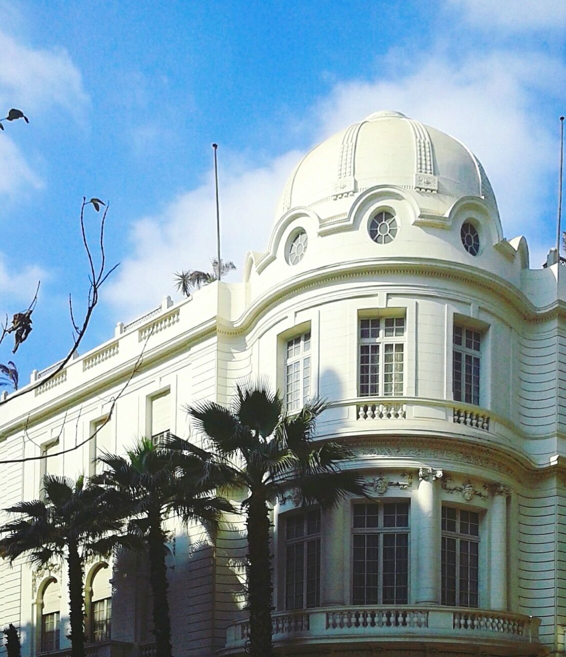 architecture, building exterior, built structure, sky, day, outdoors, low angle view, no people, tree, palm tree