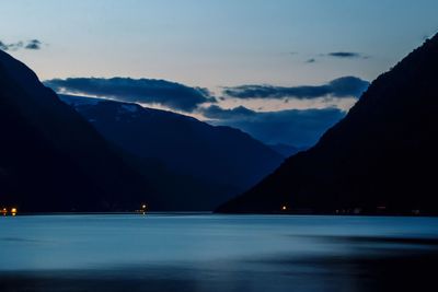 Scenic view of sea and mountains at night