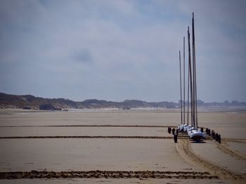 Sailboat on beach against sky