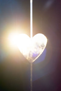 Close-up of heart shape against bright sun