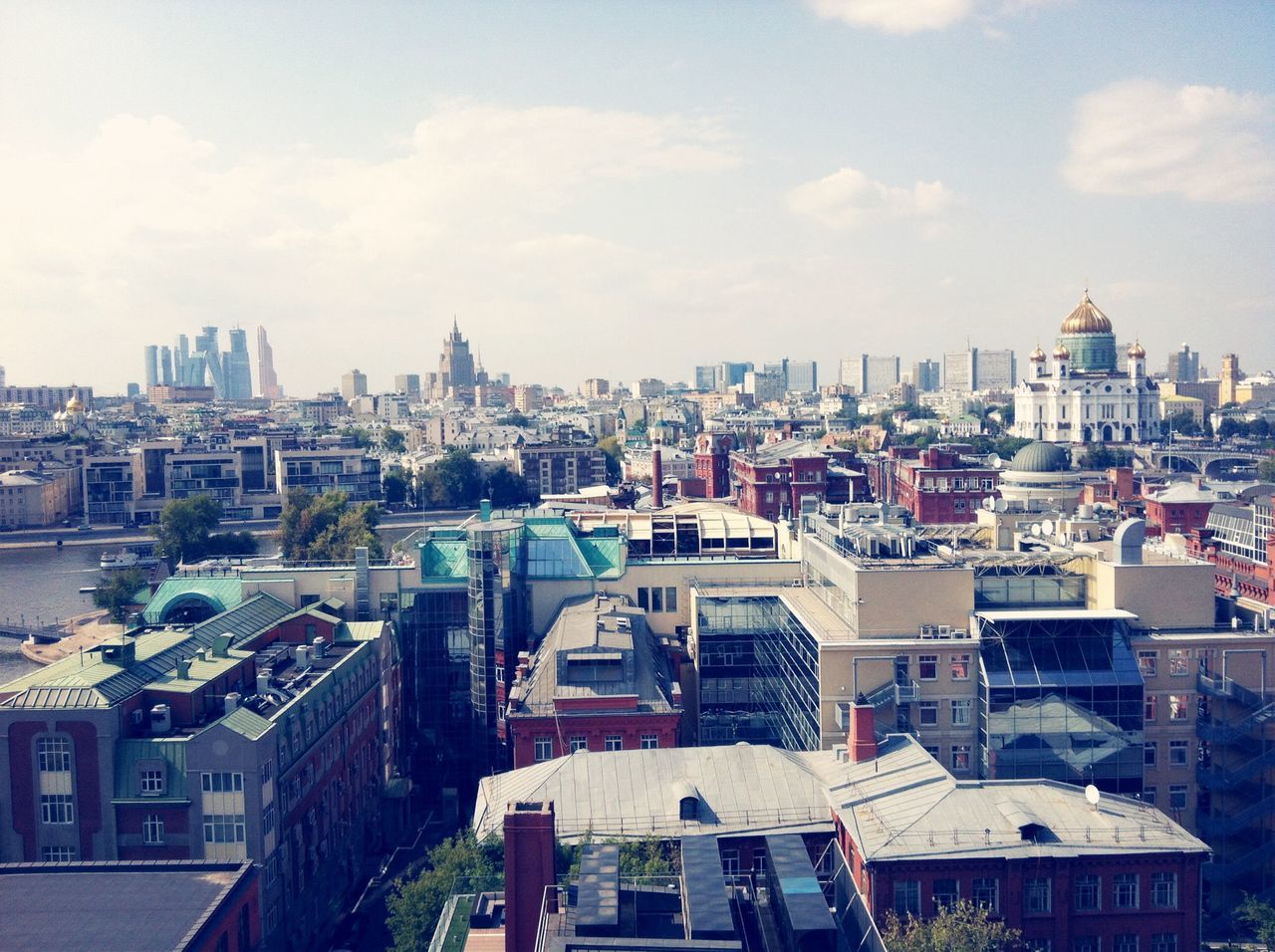 building exterior, architecture, built structure, city, sky, cityscape, residential building, residential structure, residential district, cloud - sky, city life, crowded, high angle view, building, day, cloud, railing, outdoors, incidental people, water