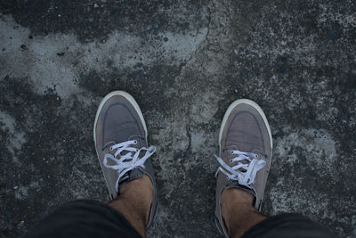 Low section of man standing on ground