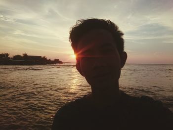 Portrait of man at beach during sunset