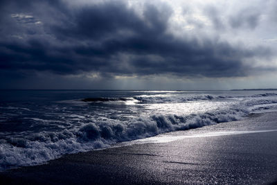 Scenic view of sea against cloudy sky