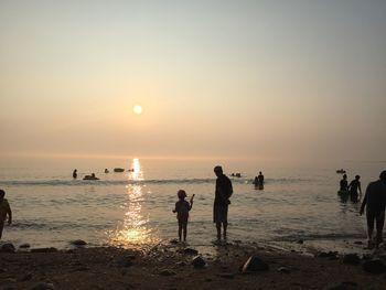 Silhouette of people on beach