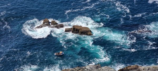 High angle view of rocks in sea