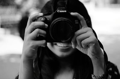 Portrait of woman photographing