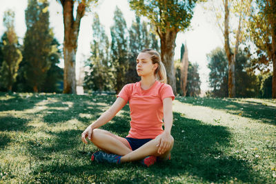 Full length of woman doing yoga on land