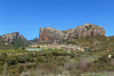 Scenic view of rocky mountains against clear blue sky