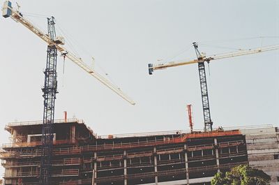 Low angle view of crane against clear sky